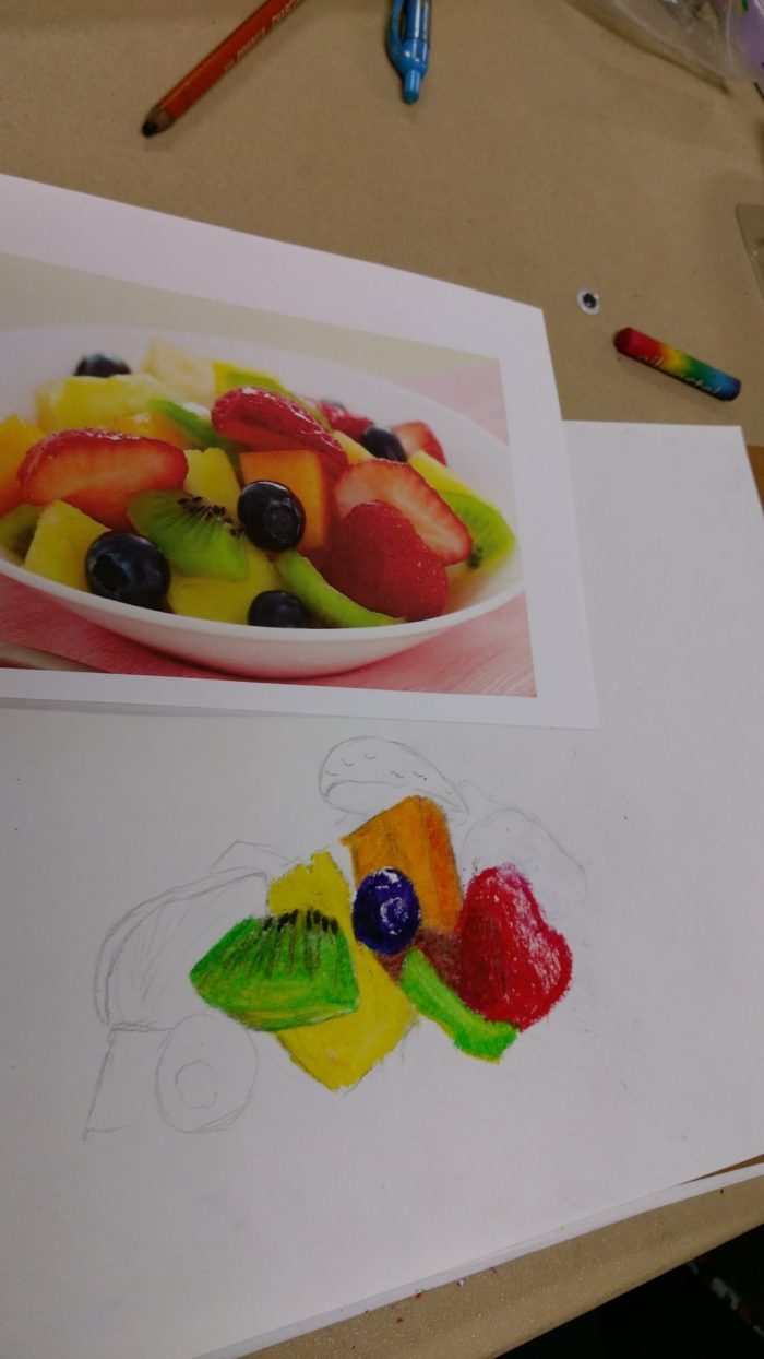 Close-up drawings of fruits with watercolor pencils