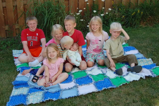 8 kids on picnic quilt